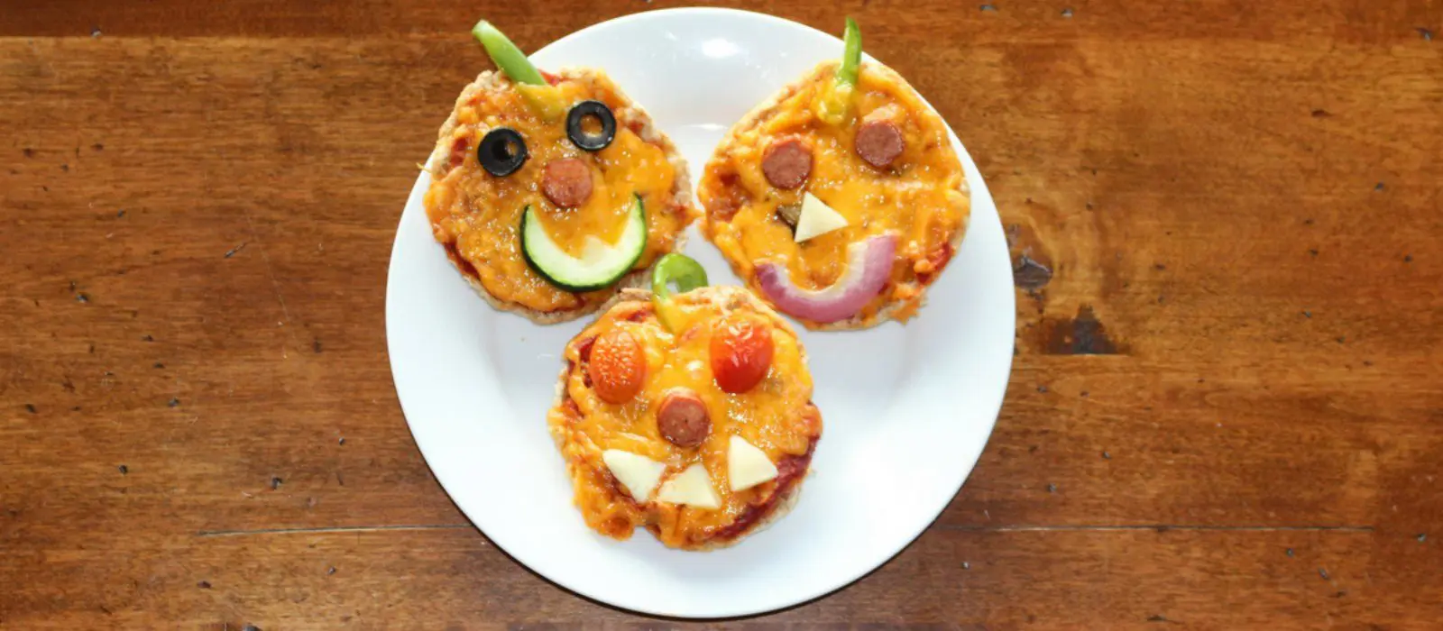 Jack-O’-Lantern Mini Pizzas with Double Cheddar
