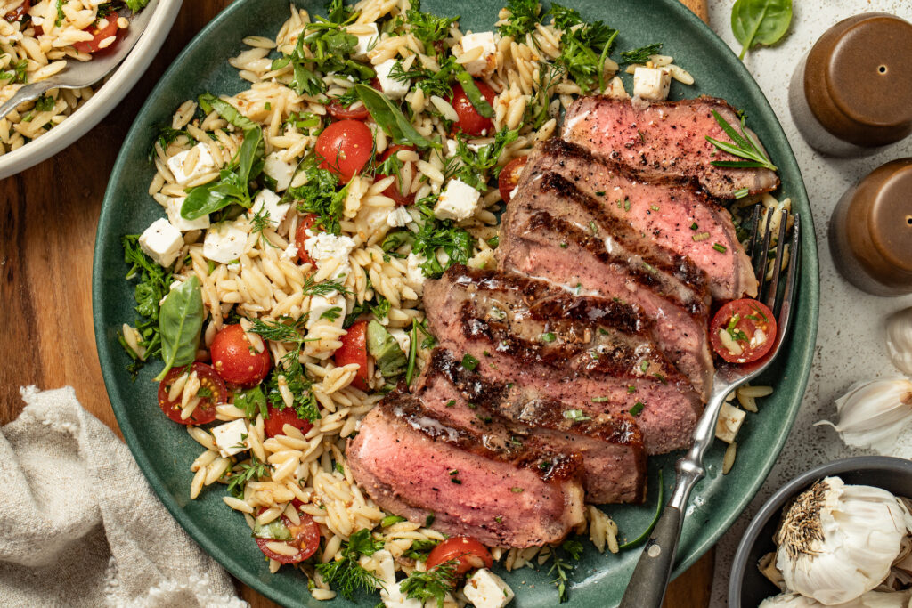 Garlic butter steak with tomato orzo salad - Alberta Milk